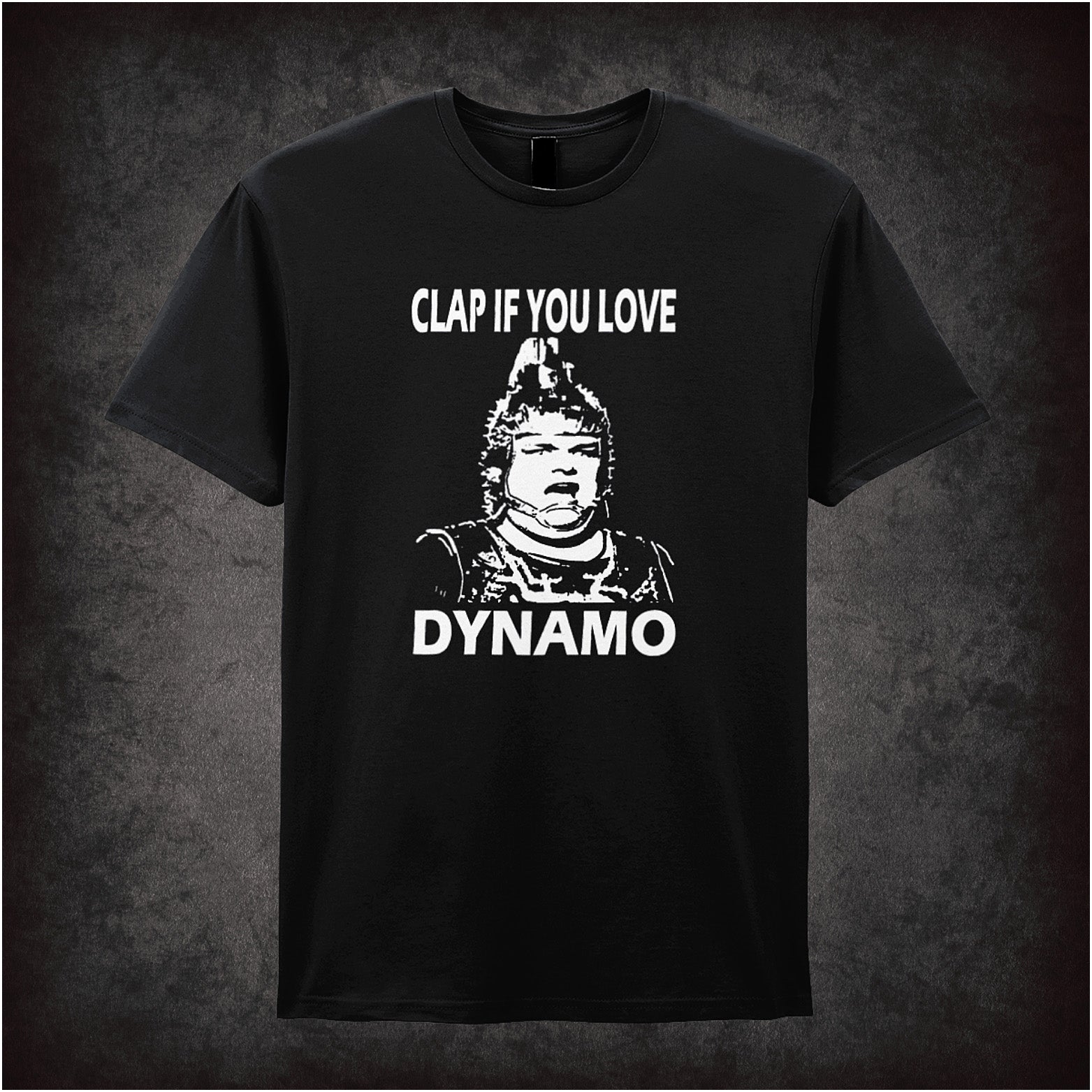 Black unisex T-shirt featuring the phrase "Clap If You Love Dynamo" inspired by The Running Man, with bold, retro-style lettering.