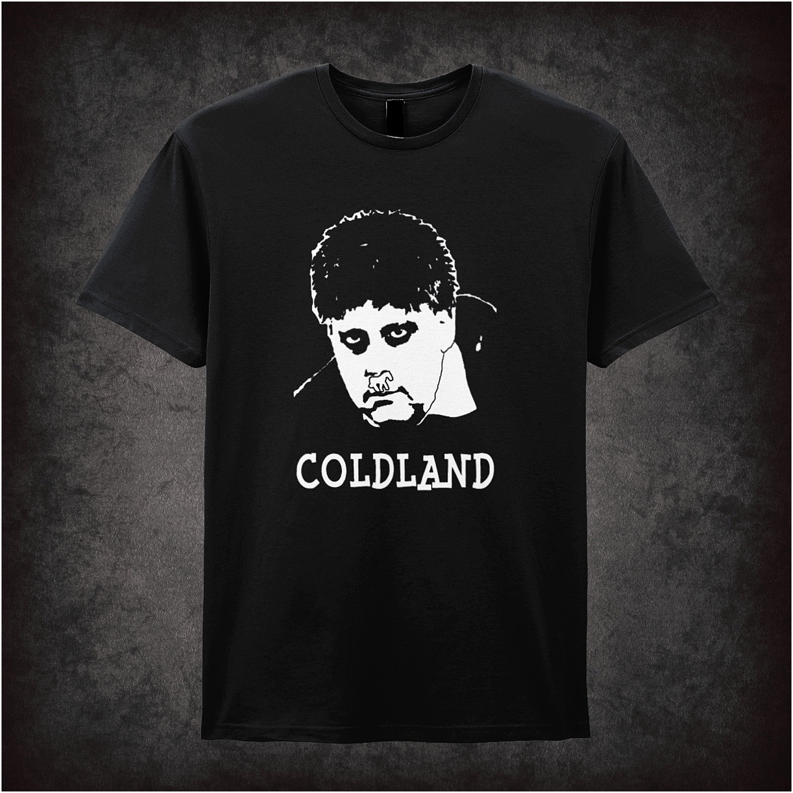 Black soft style unisex T-shirt featuring the text "Coldland" inspired by Vic and Bob, designed in a quirky, bold style reflecting their surreal comedy.