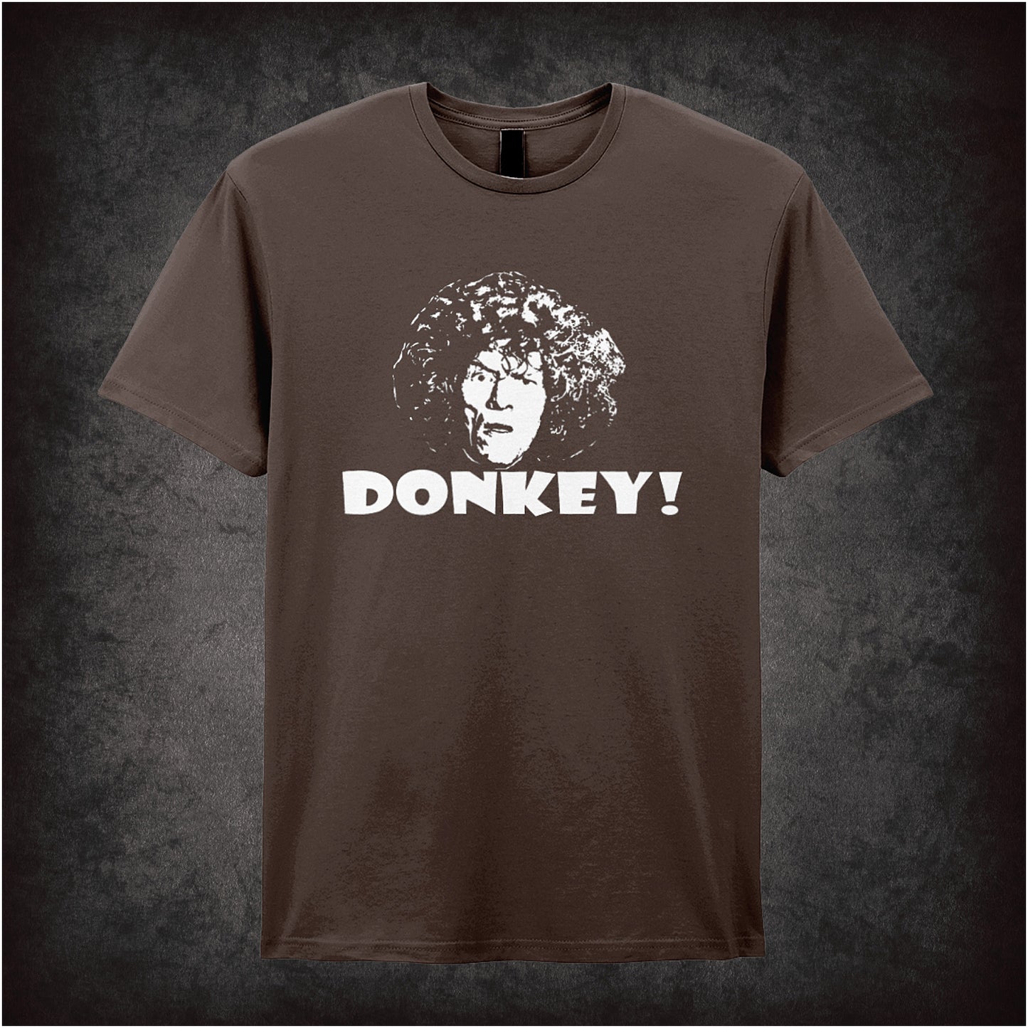 chocolate soft style unisex T-shirt featuring the word "Donkey" inspired by Shooting Stars, styled in bold, quirky lettering reflecting the show’s absurd humour.