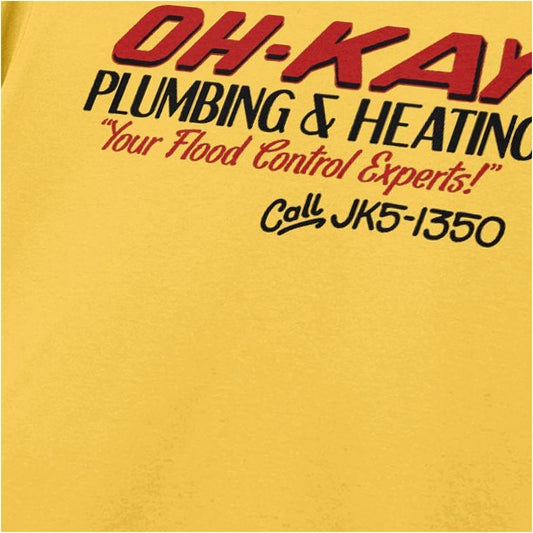 Close-up of oh-Kay Plumbing and Heating logo T-shirt in daisy yellow from Home Alone