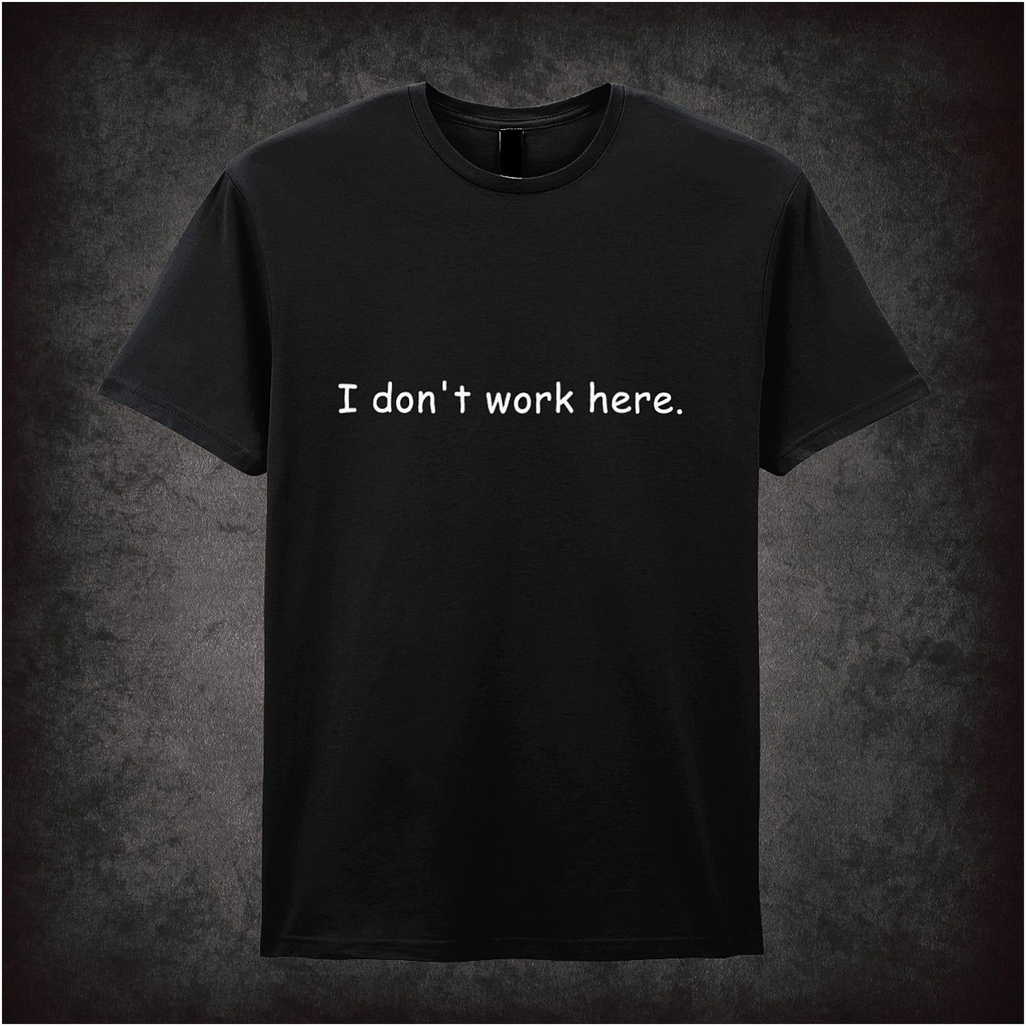 Black soft style unisex T-shirt featuring the quote "I Don't Work Here" inspired by The IT Crowd, displayed in bold, comedic-style lettering.