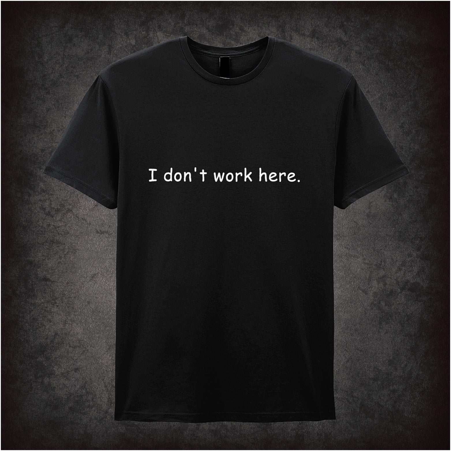 Black soft style unisex T-shirt featuring the quote "I Don't Work Here" inspired by The IT Crowd, displayed in bold, comedic-style lettering.
