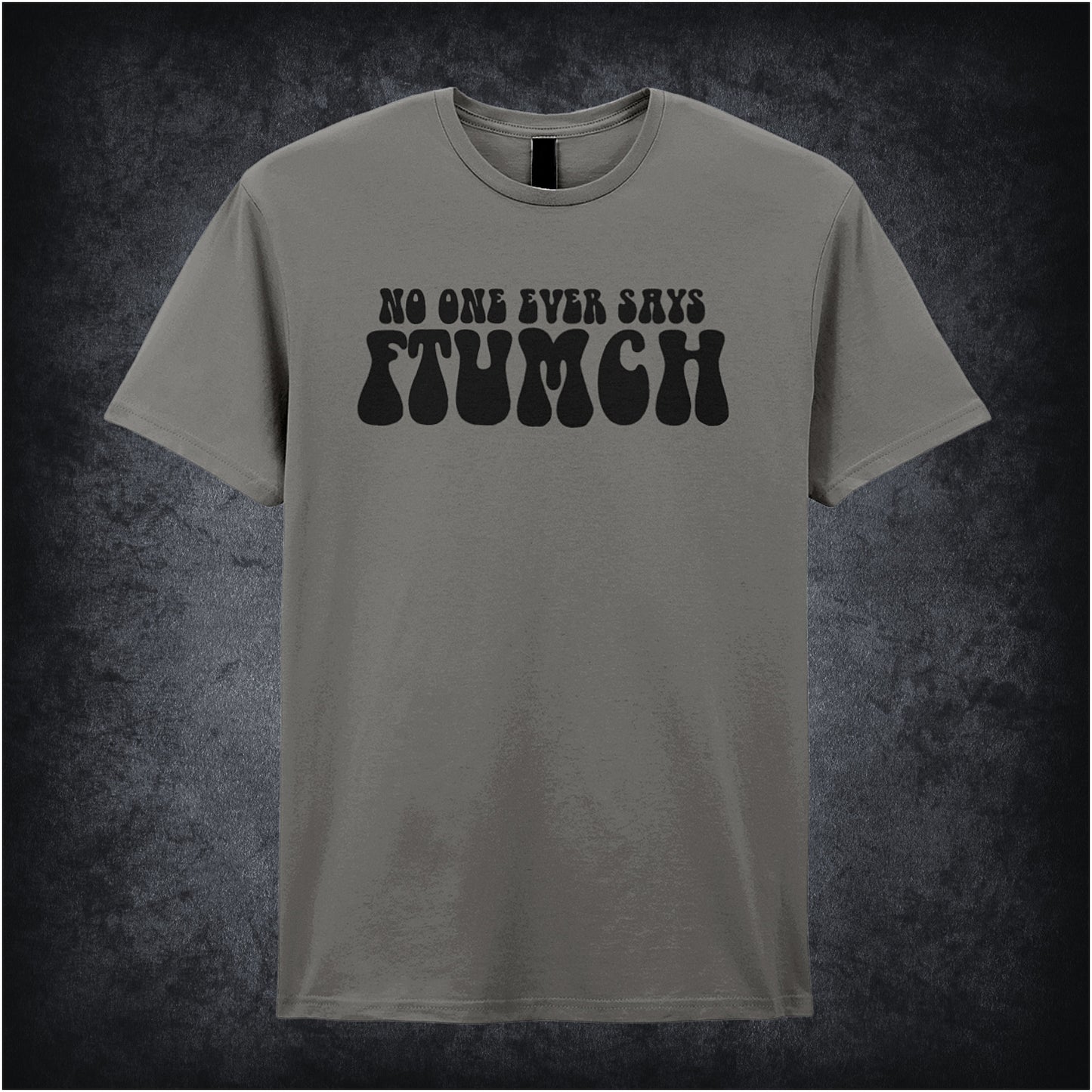 charcoal unisex t-shirt featuring the phrase “No One Ever Says Ftumch” inspired by The Young Ones TV show, with playful, bold lettering.