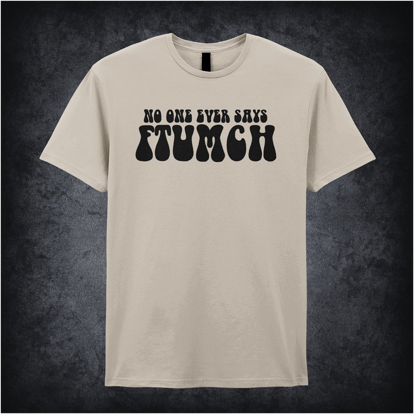 natural unisex t-shirt featuring the phrase “No One Ever Says Ftumch” inspired by The Young Ones TV show, with playful, bold lettering.