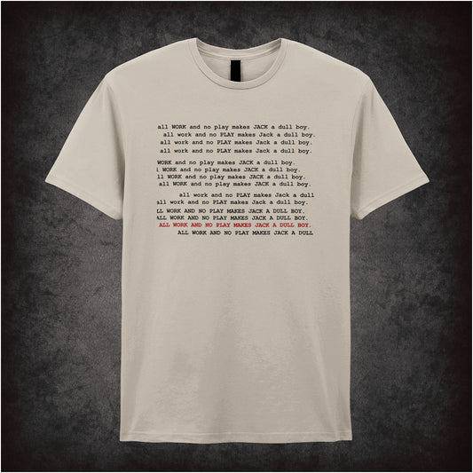 natural unisex t-shirt featuring the phrase “All Work And No Play Makes Jack A Dull Boy” inspired by the movie The Shining, displayed in bold, black typewriter-style lettering.