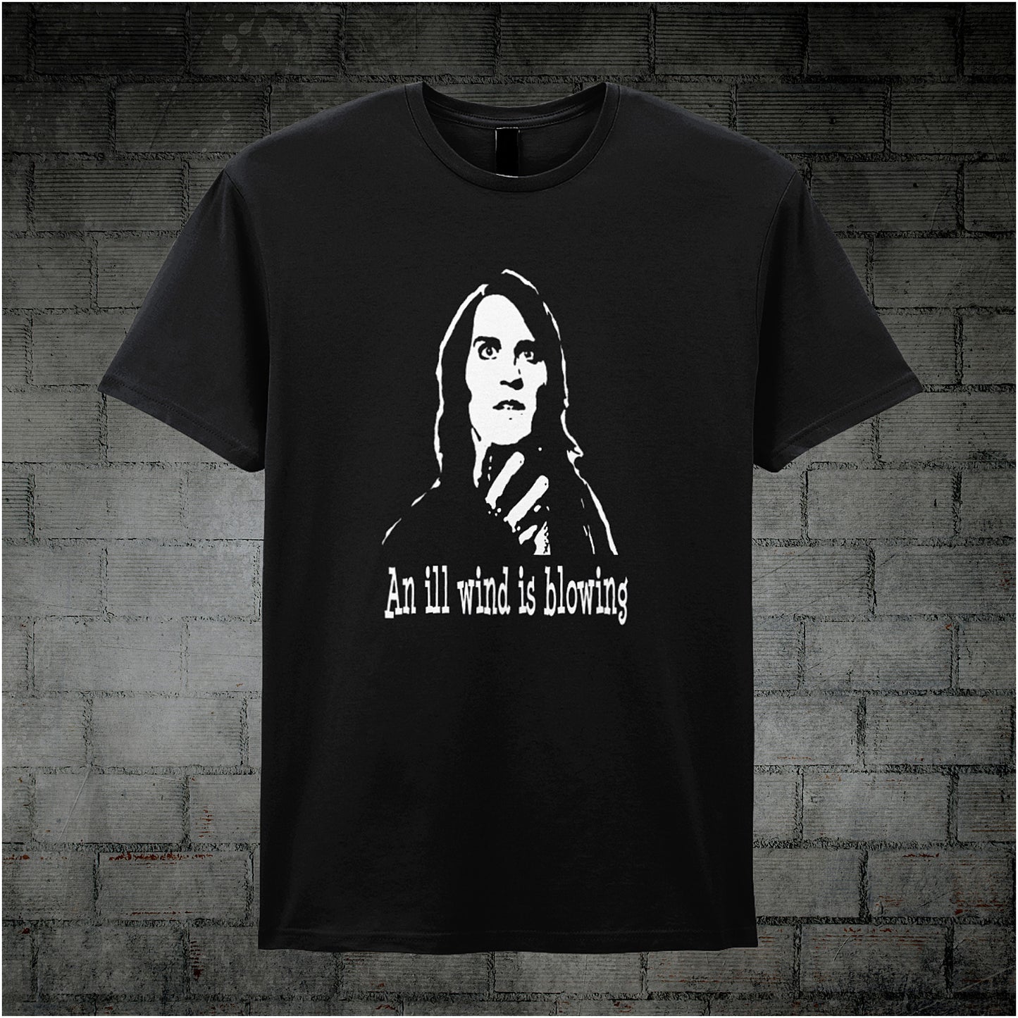 Black unisex T-shirt featuring the phrase “An Ill Wind Is Blowing” inspired by The IT Crowd, displayed in bold white text with a dramatic, minimalist design.