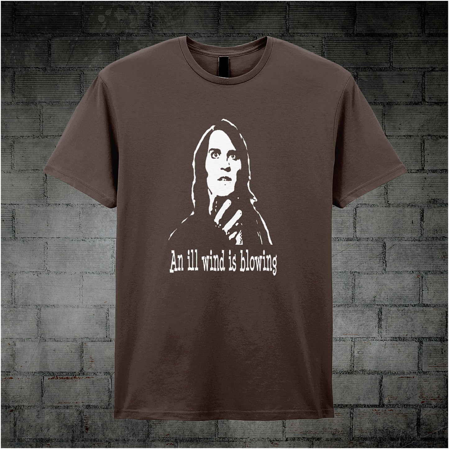 chocolate unisex T-shirt featuring the phrase “An Ill Wind Is Blowing” inspired by The IT Crowd, displayed in bold white text with a dramatic, minimalist design.
