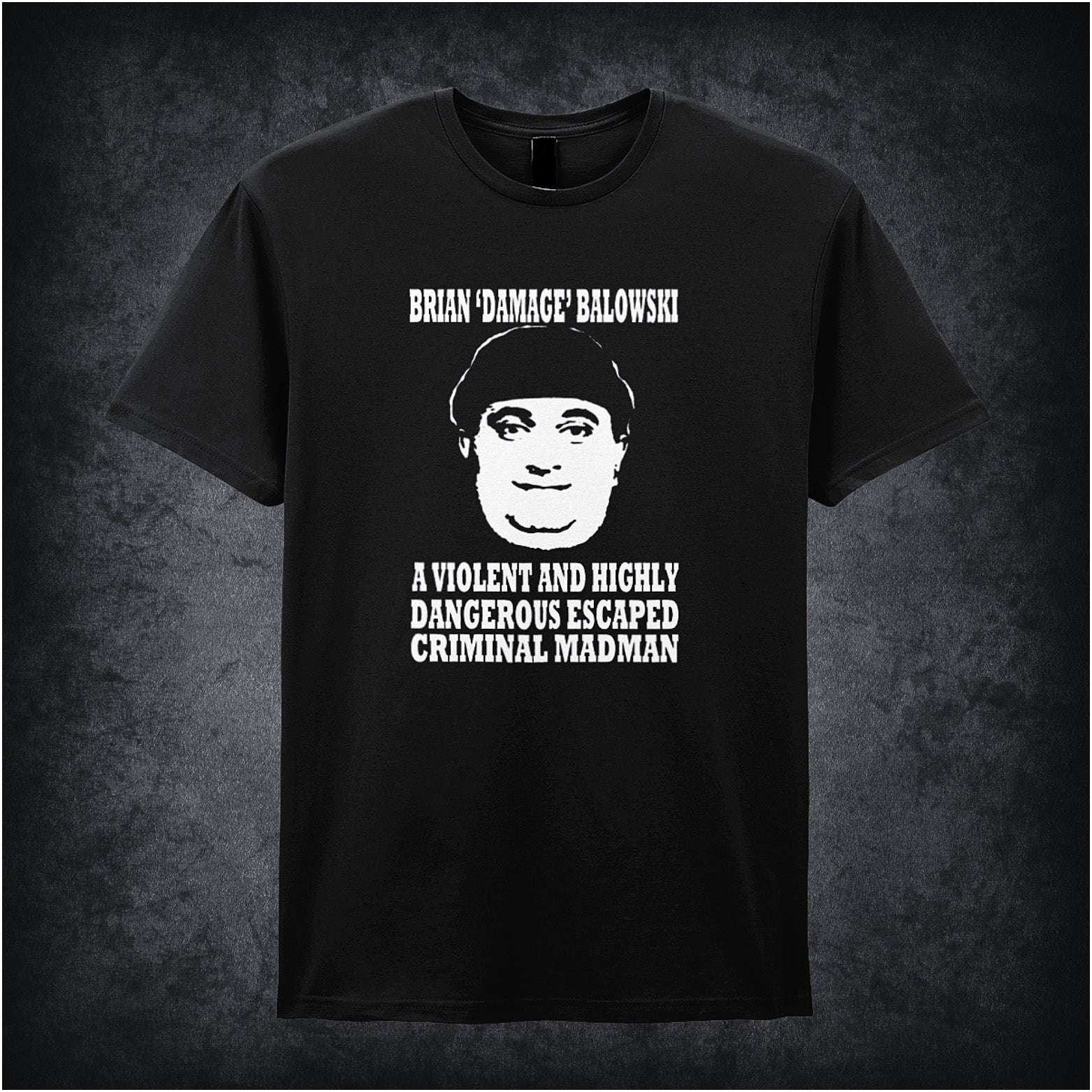 black unisex T-shirt featuring the phrase “Brian Damage Balowski: A Violent And Highly Dangerous Escaped Criminal Madman” inspired by The Young Ones, displayed in bold white text with a chaotic, anarchic style.