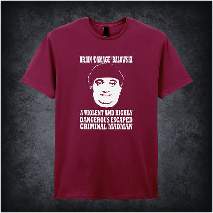 cardinal red unisex T-shirt featuring the phrase “Brian Damage Balowski: A Violent And Highly Dangerous Escaped Criminal Madman” inspired by The Young Ones, displayed in bold white text with a chaotic, anarchic style.