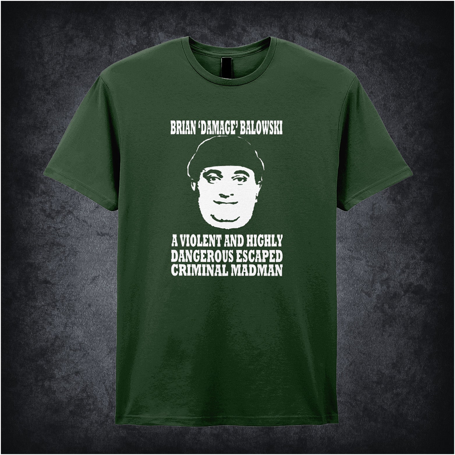 forest unisex T-shirt featuring the phrase “Brian Damage Balowski: A Violent And Highly Dangerous Escaped Criminal Madman” inspired by The Young Ones, displayed in bold white text with a chaotic, anarchic style.