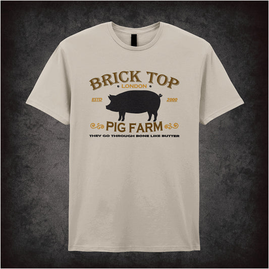 Natural coloured unisex t-shirt featuring the text “Brick Top Pig Farm” styled with a gritty design inspired by the movie Snatch.