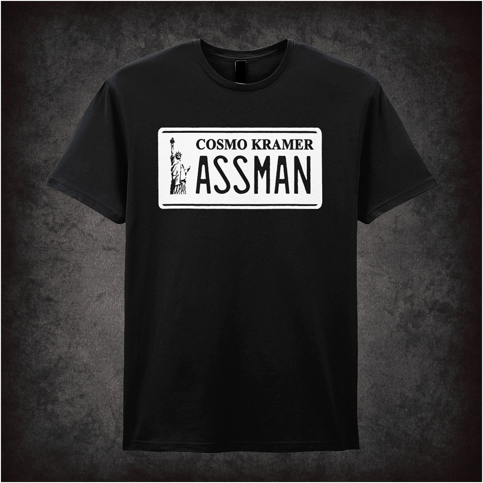 black unisex T-shirt featuring “Cosmo Kramer Assman” phrase inspired by Seinfeld, displayed in bold, playful typography.