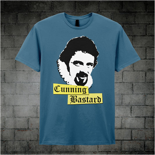 indigo unisex T-shirt featuring the phrase “Cunning Bastard” inspired by Blackadder, displayed in bold, classic serif typography.