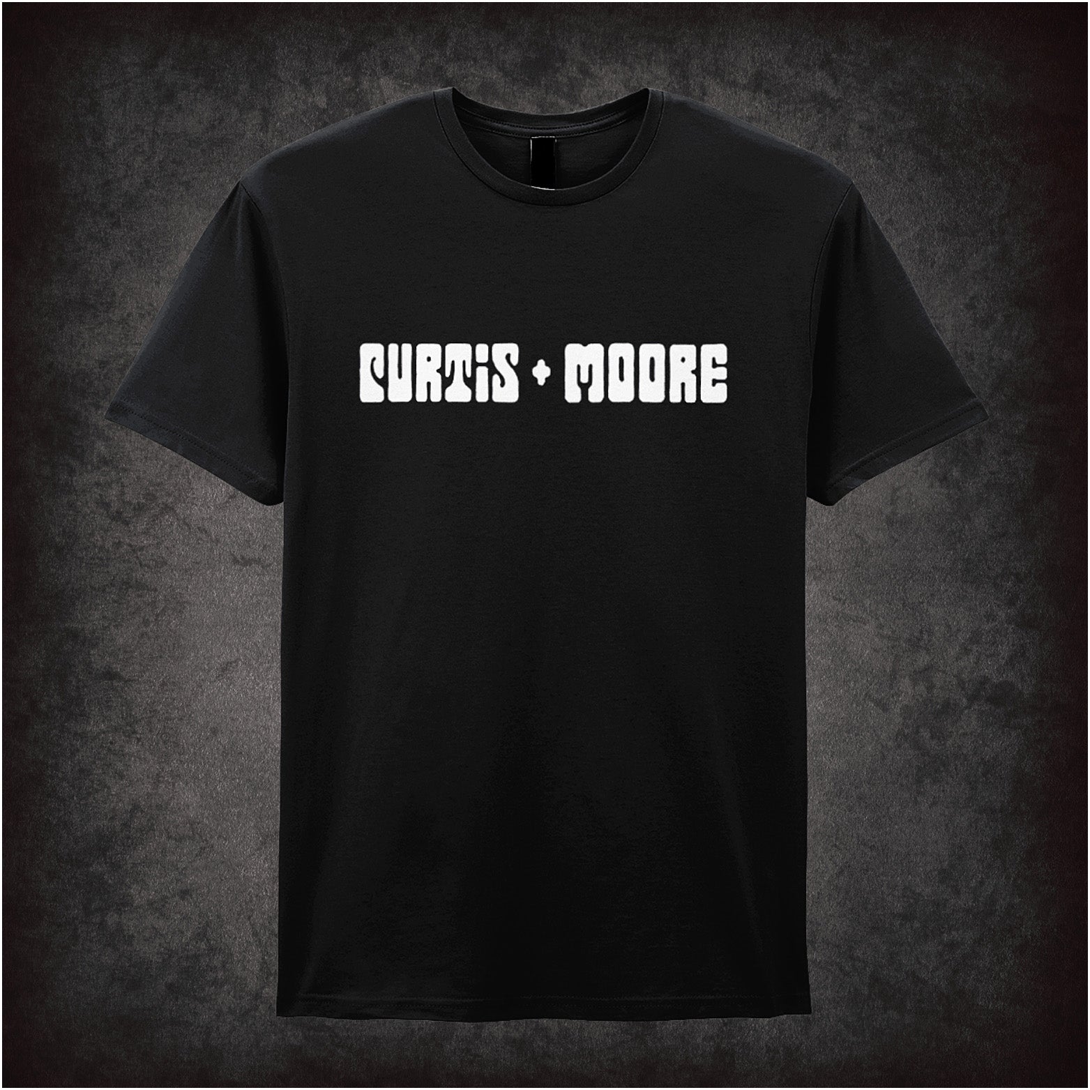 black soft style unisex T-shirt featuring a stylish Curtis and Moore design inspired by The Persuaders!, with bold retro 70s-inspired graphics.