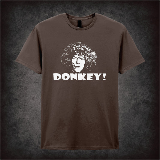 chocolate soft style unisex T-shirt featuring the word "Donkey" inspired by Shooting Stars, styled in bold, quirky lettering reflecting the show’s absurd humour.