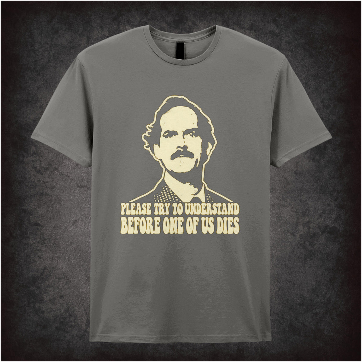 “Basil Fawlty ‘Please try to understand before one of us dies’ T-shirt in charcoal from Fawlty Towers”
