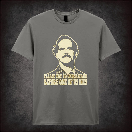 “Basil Fawlty ‘Please try to understand before one of us dies’ T-shirt in charcoal from Fawlty Towers”