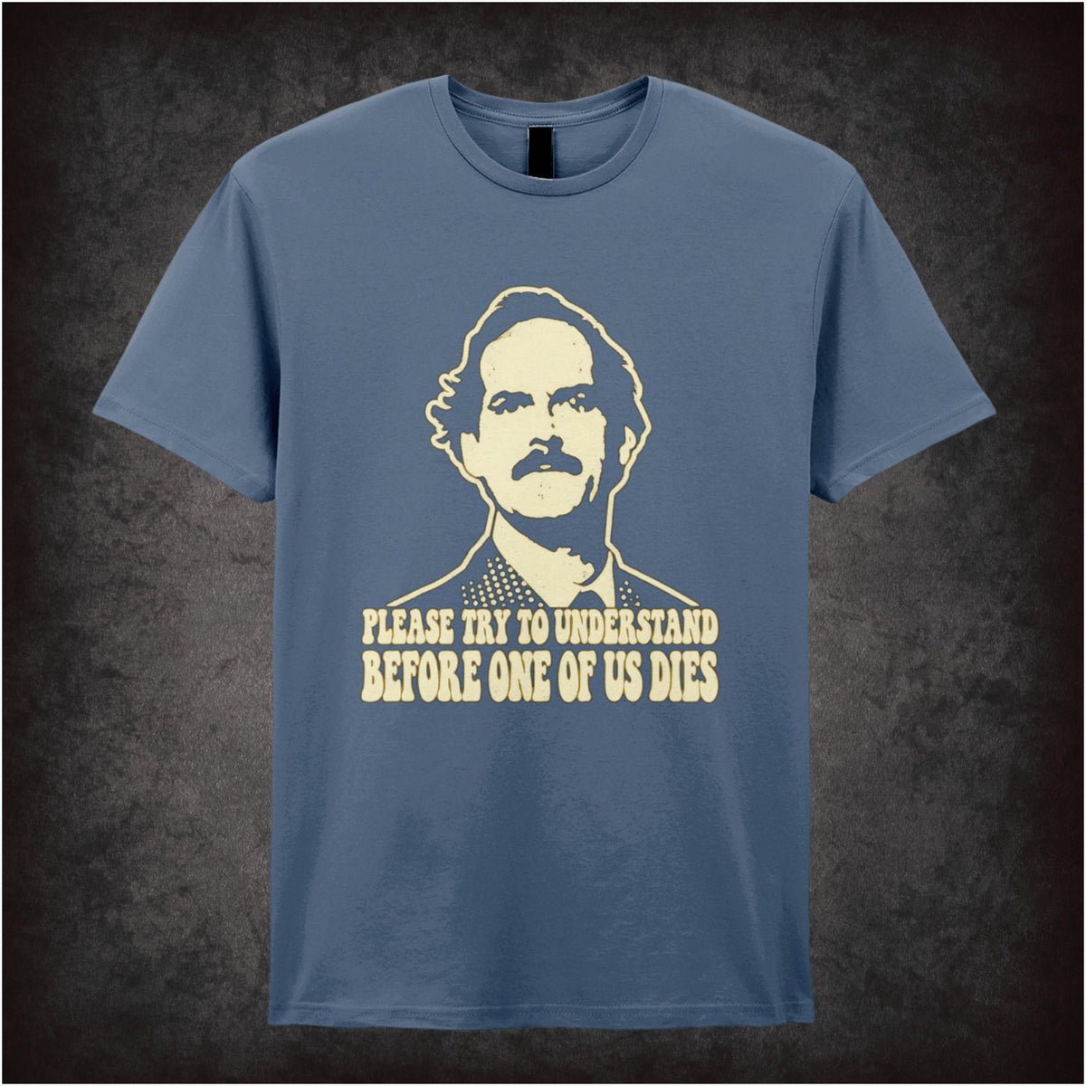 “Basil Fawlty ‘Please try to understand before one of us dies’ T-shirt in indigo from Fawlty Towers”