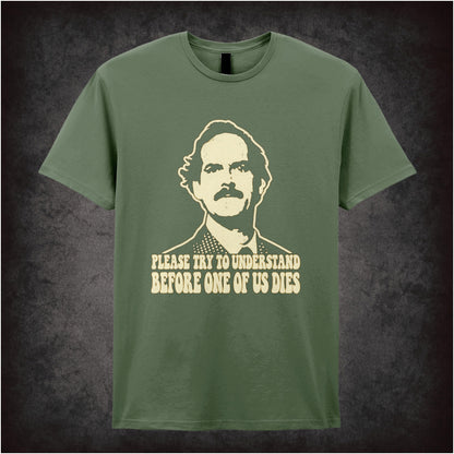 “Basil Fawlty ‘Please try to understand before one of us dies’ T-shirt in military green from Fawlty Towers”