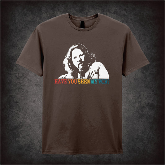 chocolate soft style unisex T-shirt featuring the phrase "Have You Seen My VCR?" inspired by The Big Lebowski, in bold, vintage-style lettering.