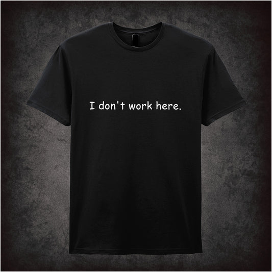 Black soft style unisex T-shirt featuring the quote "I Don't Work Here" inspired by The IT Crowd, displayed in bold, comedic-style lettering.