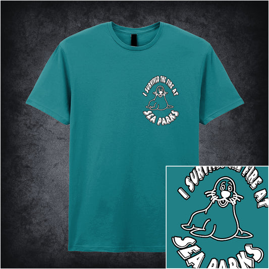 indigo soft style unisex T-shirt featuring the phrase "I Survived the Fire at Sea Parks" inspired by The IT Crowd, with bold, playful typography.