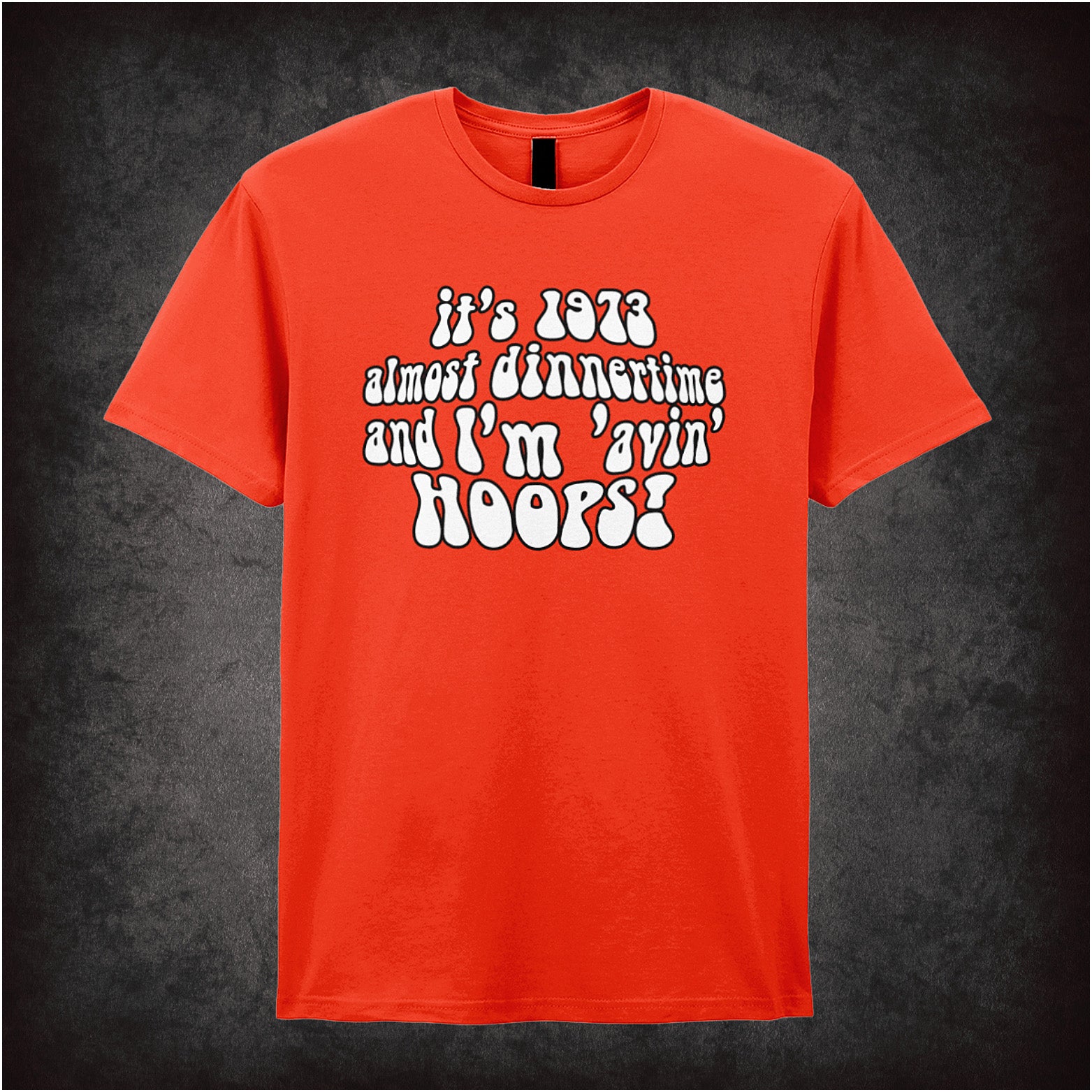 orange soft style unisex T-shirt featuring the quote "It's 1973, almost dinnertime and I'm 'avin' hoops" inspired by Life on Mars in bold retro lettering.
