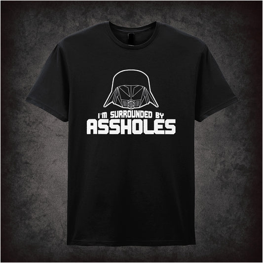 black unisex t-shirt featuring the phrase “I’m Surrounded By Assholes” in bold, humorous typography inspired by the movie Spaceballs.