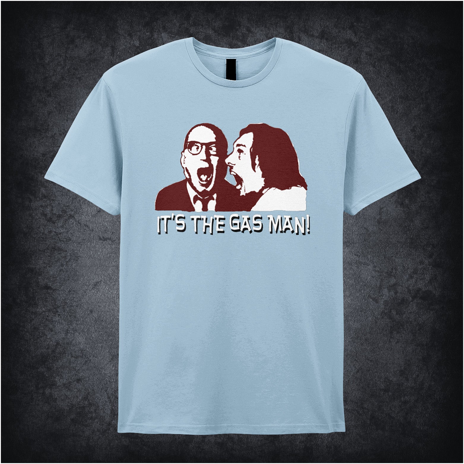 light blue unisex T-shirt featuring the phrase “It's The Gas Man!” inspired by Bottom, displayed in bold white lettering with a comedic, punchy style.