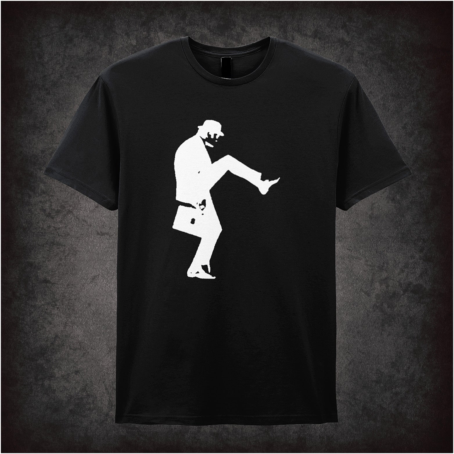 Black unisex t-shirt featuring a silhouette graphic of John Cleese doing his famous Silly Walk, wearing a bowler hat and carrying a briefcase, inspired by Monty Python.