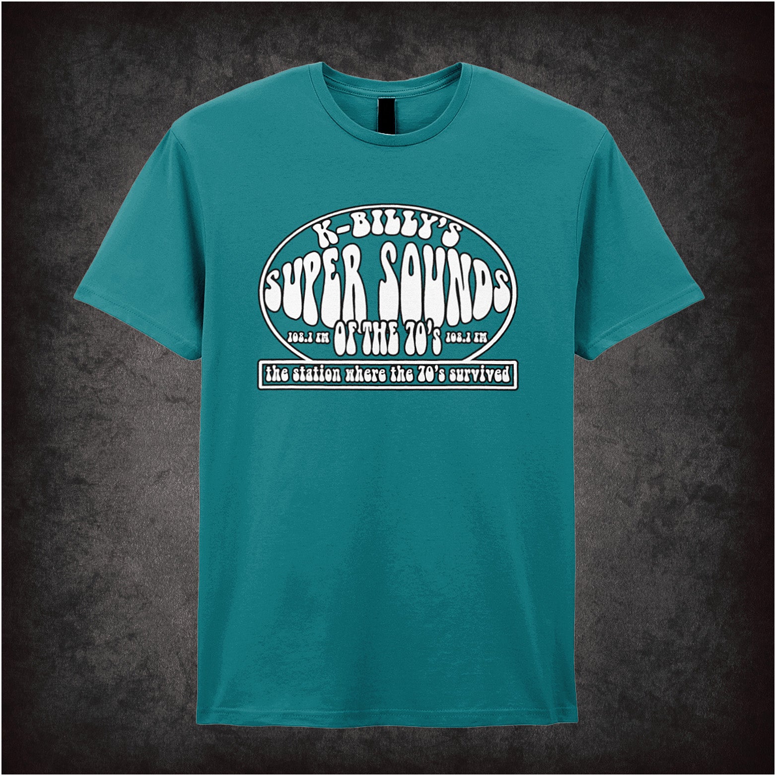 antique sapphire unisex T-shirt featuring “K-Billy's Super Sounds Of The '70s” design inspired by Reservoir Dogs, displayed in bold retro-style white lettering.