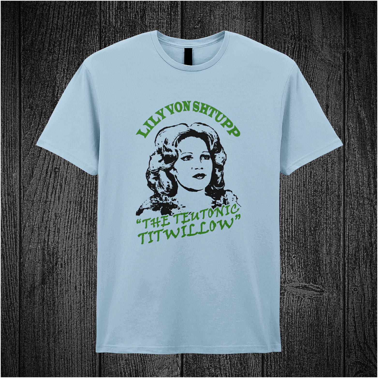Lily Von Shtupp The Teutonic Titwillow – Blazing Saddles-inspired design featuring stylized text and vintage theatrical elements printed on a light blue coloured unisex t-shirt.