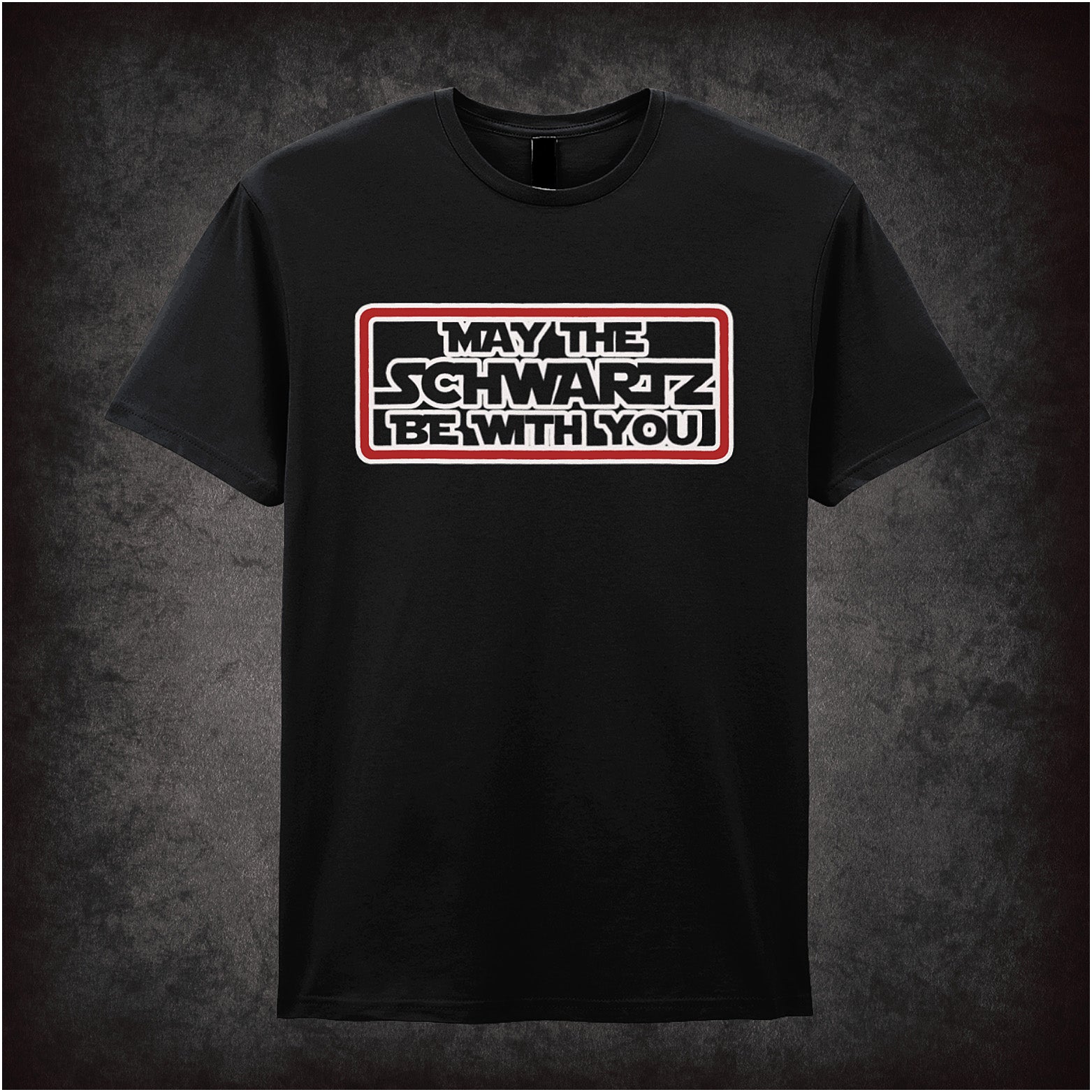 Black soft style unisex T-shirt featuring the phrase "May The Schwartz Be With You" inspired by Spaceballs, styled in bold sci-fi lettering.