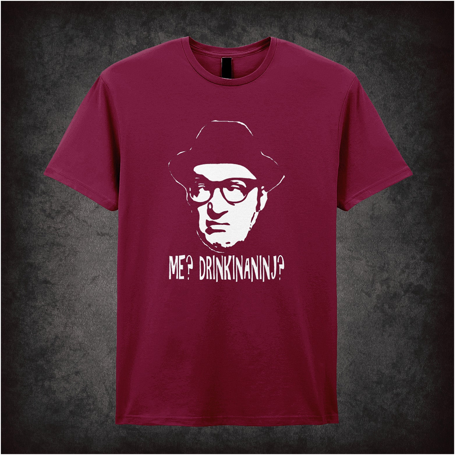 Soft style cardinal red unisex T-shirt featuring the quote "Me? Drinkinaninj?" inspired by Bottom, printed in bold, playful lettering reflecting the show's anarchic humour.