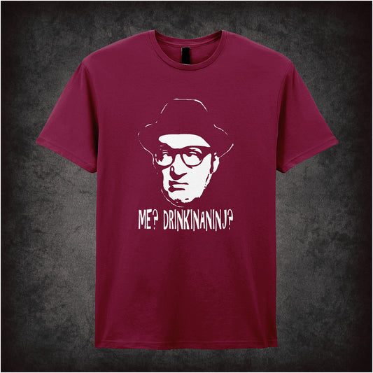 Soft style cardinal red unisex T-shirt featuring the quote "Me? Drinkinaninj?" inspired by Bottom, printed in bold, playful lettering reflecting the show's anarchic humour.