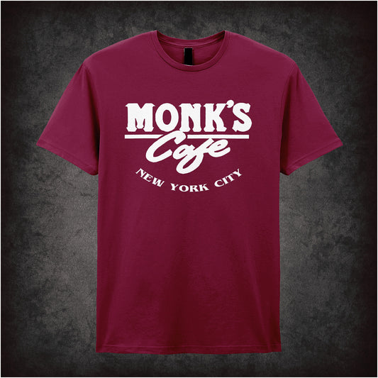cardinal red unisex T-shirt featuring “Monk's Cafe New York City” design inspired by Seinfeld, with vintage diner-style lettering.