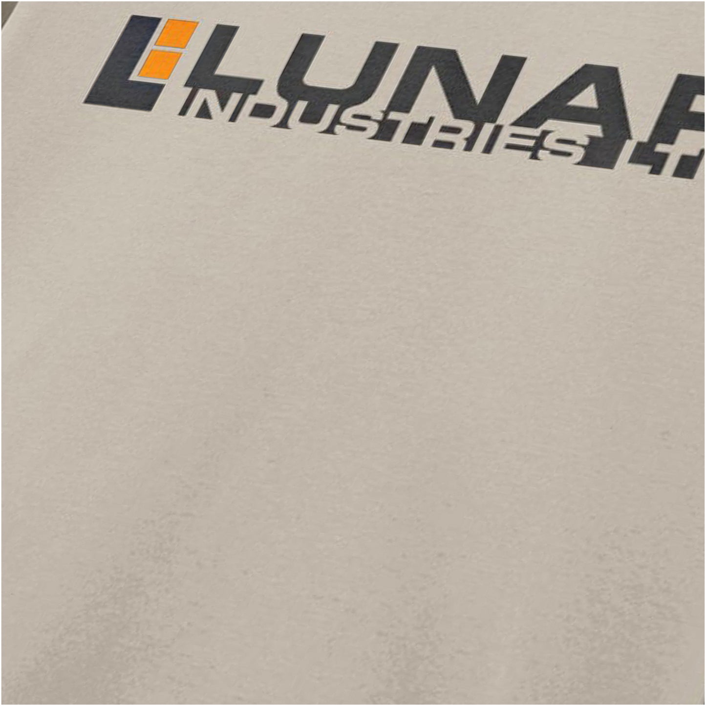 Close-up of lunar Industries logo T-shirt in sand from Moon