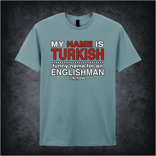 light blue unisex t-shirt featuring the phrase “My Name Is Turkish Funny Name For An Englishman I Know” inspired by the movie Snatch, displayed in bold red and white lettering.