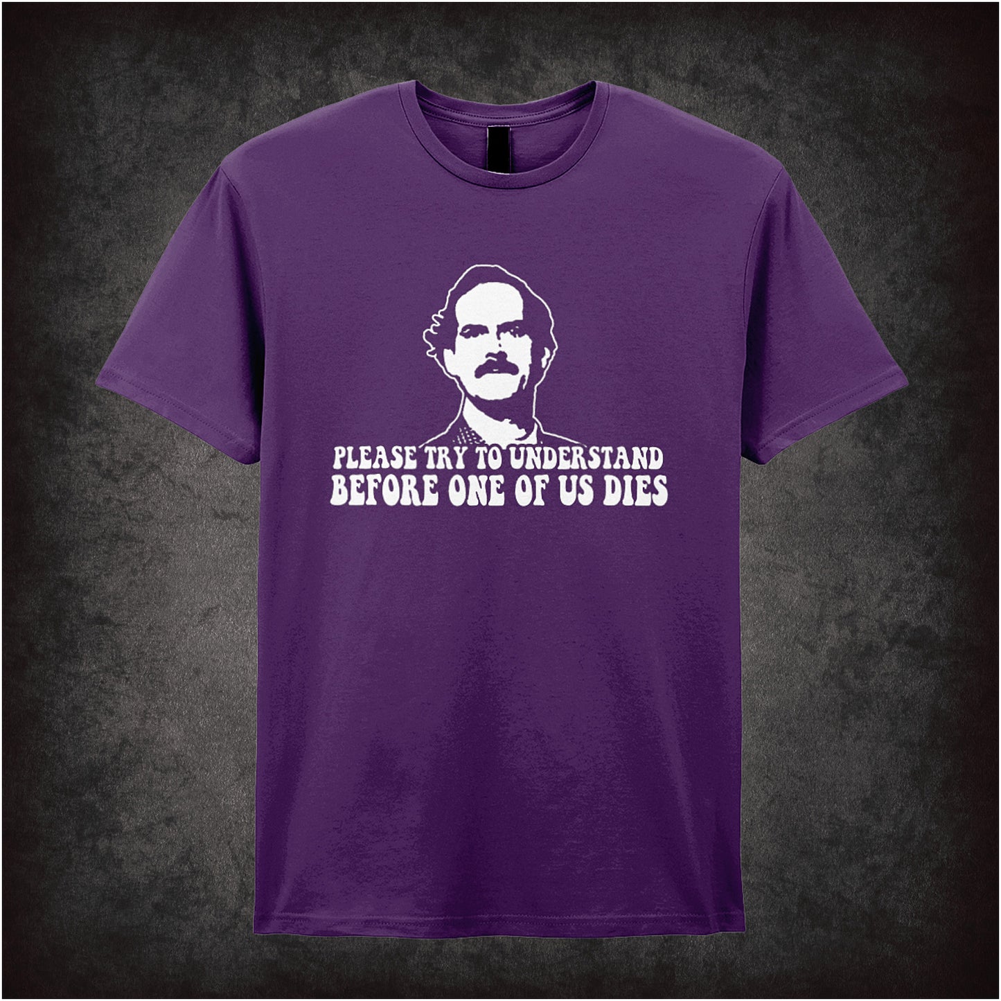 purple Soft style unisex T-shirt with the quote "Please Try to Understand Before One of Us Dies," inspired by Fawlty Towers, in a bold comedic design.