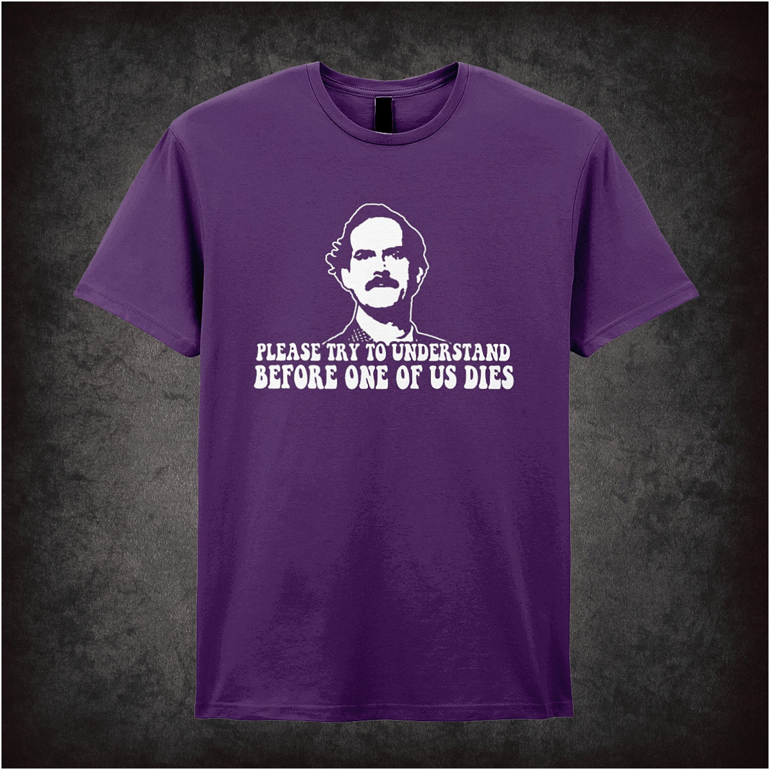 purple Soft style unisex T-shirt with the quote "Please Try to Understand Before One of Us Dies," inspired by Fawlty Towers, in a bold comedic design.