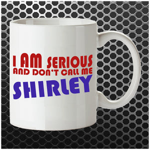 White mug featuring the funny Airplane! movie quote 'I am serious... and don’t call me Shirley' by Ted Striker and Leslie Nielsen.