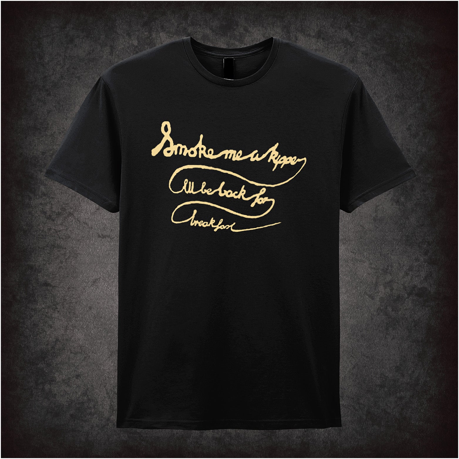 Black soft style unisex T-shirt featuring the quote "Smoke Me a Kipper, I'll Be Back for Breakfast" inspired by Red Dwarf, in bold, playful lettering.