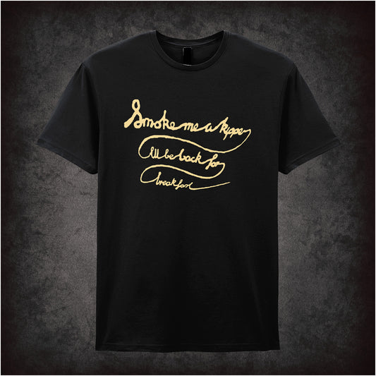 Black soft style unisex T-shirt featuring the quote "Smoke Me a Kipper, I'll Be Back for Breakfast" inspired by Red Dwarf, in bold, playful lettering.