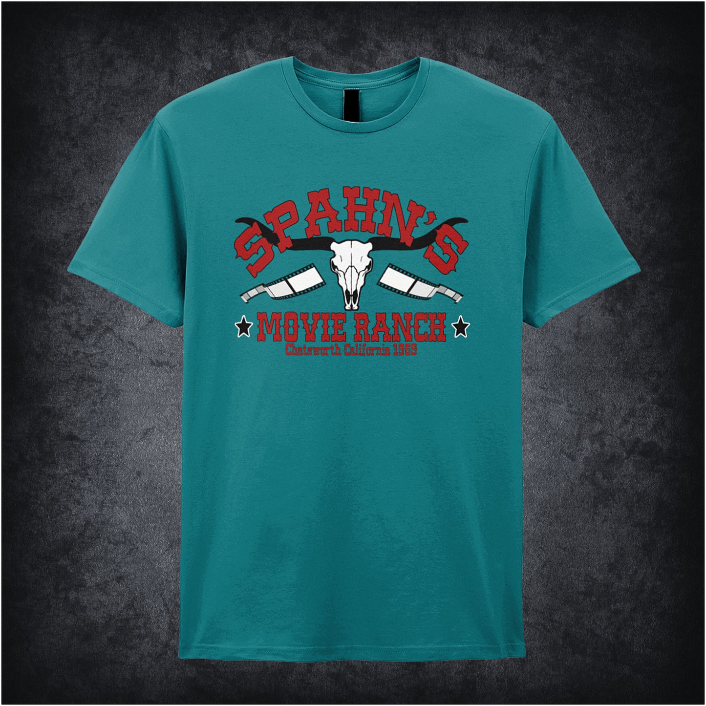 antique sapphire coloured unisex t-shirt displaying a vintage-style graphic of Spahn’s Movie Ranch, inspired by Once Upon A Time In Hollywood, with rustic lettering and a retro Western vibe.