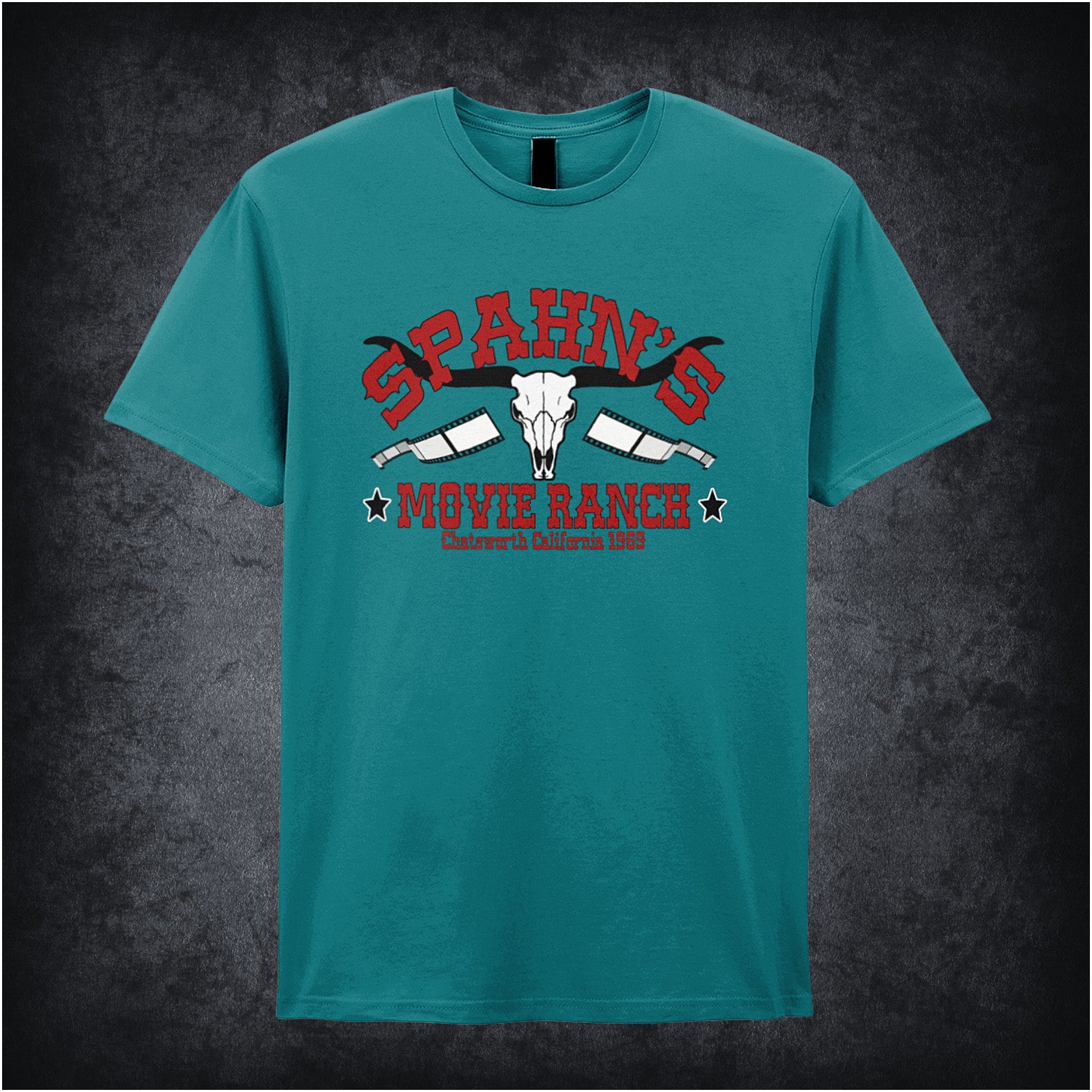 antique sapphire coloured unisex t-shirt displaying a vintage-style graphic of Spahn’s Movie Ranch, inspired by Once Upon A Time In Hollywood, with rustic lettering and a retro Western vibe.