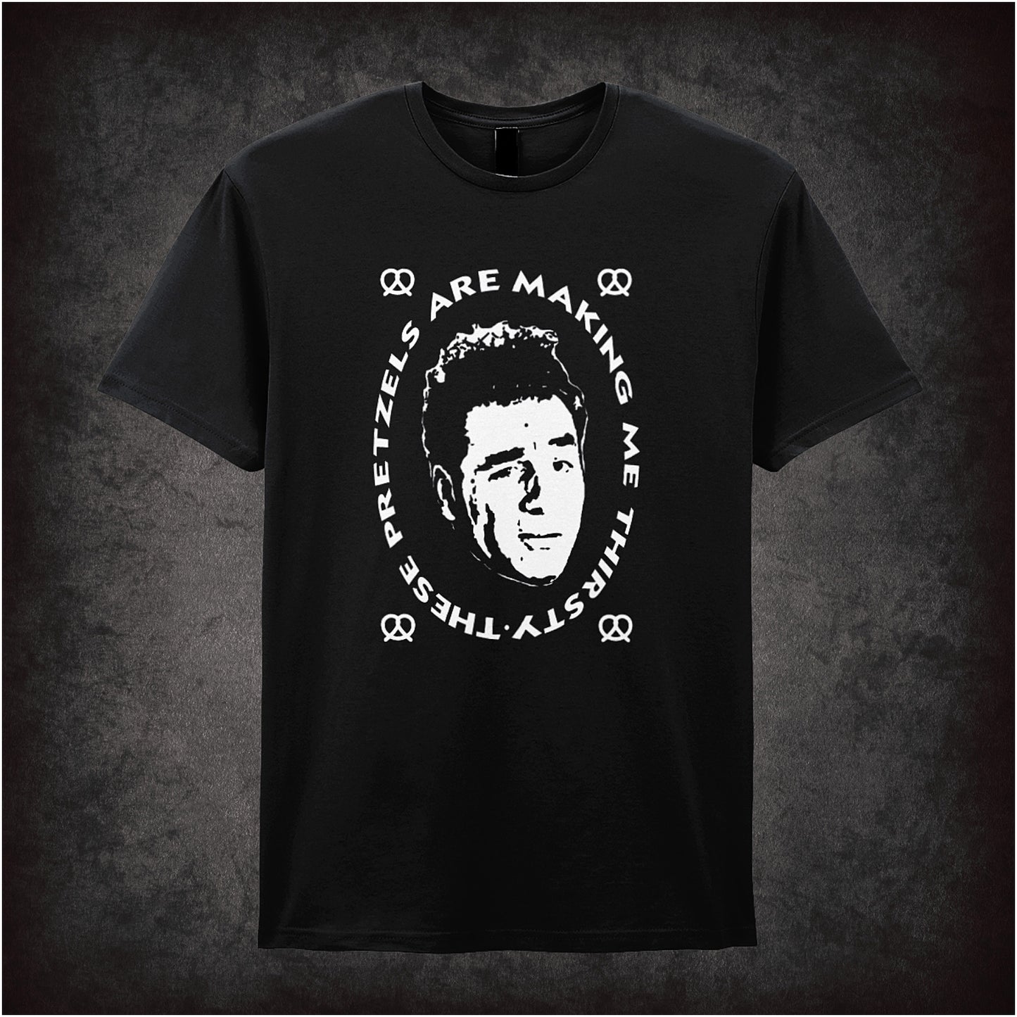 black soft style unisex T-shirt featuring the quote "These Pretzels Are Making Me Thirsty" inspired by Seinfeld, in bold, comedic lettering.