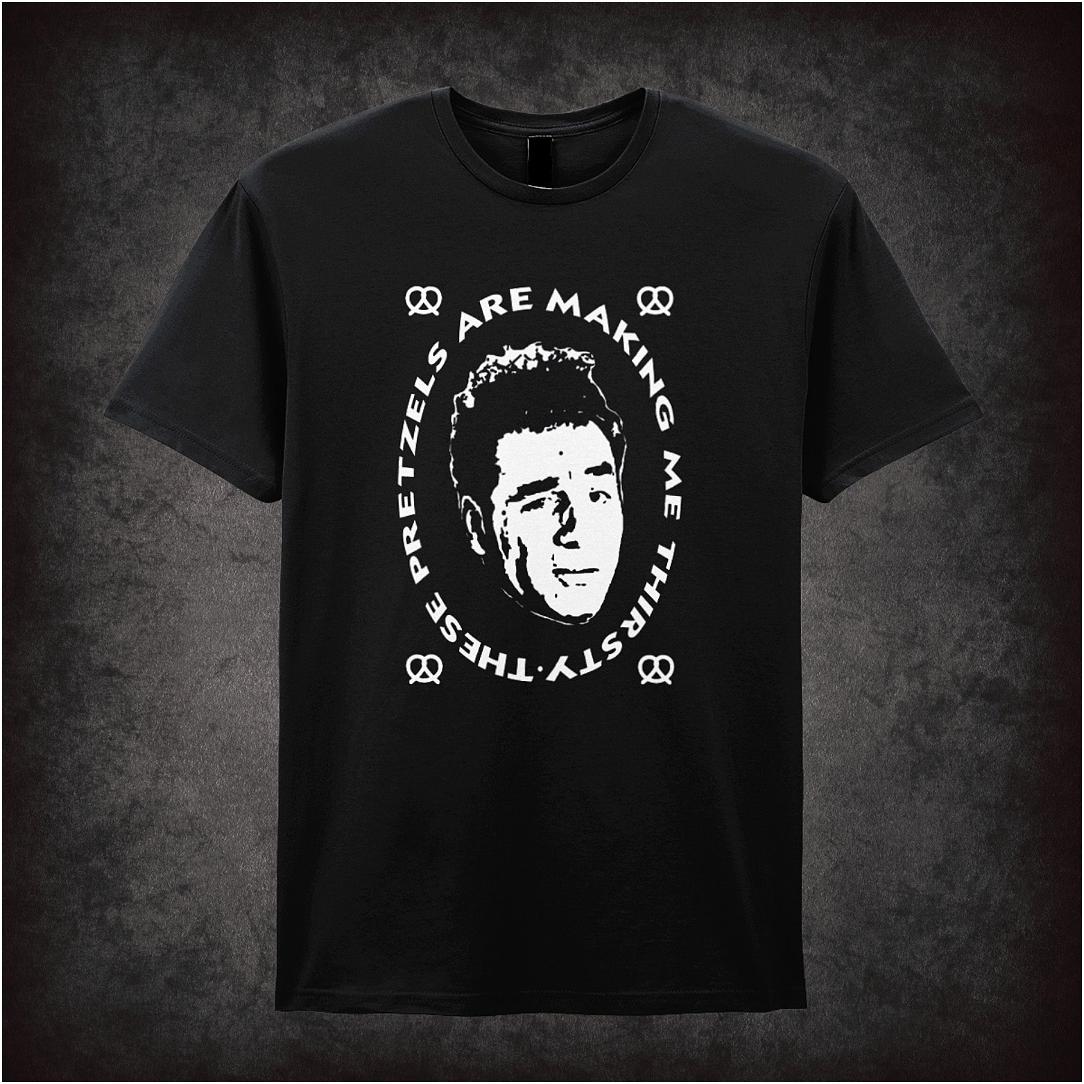 black soft style unisex T-shirt featuring the quote "These Pretzels Are Making Me Thirsty" inspired by Seinfeld, in bold, comedic lettering.
