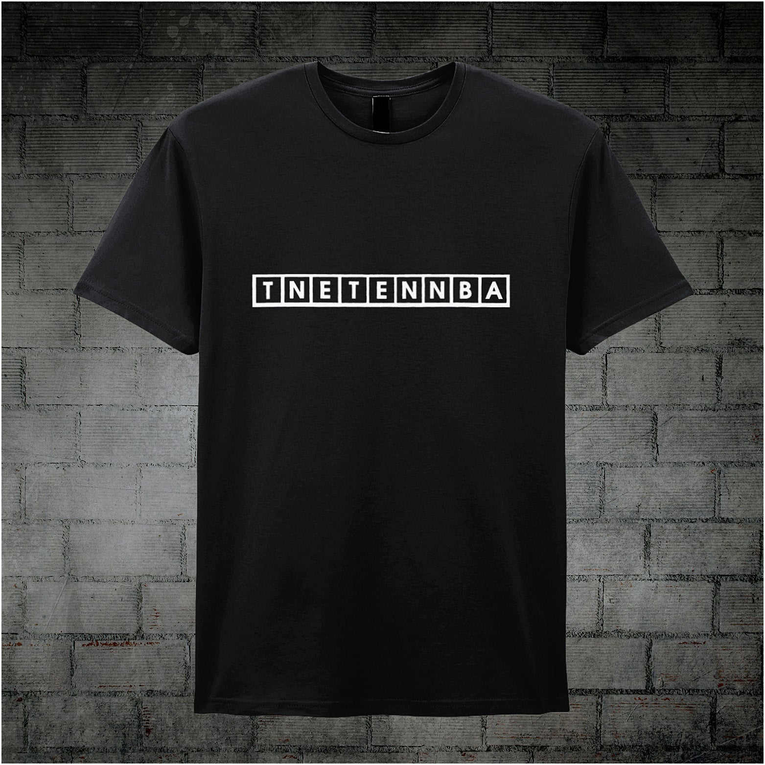 black unisex T-shirt featuring the text “TNETENNBA” inspired by The IT Crowd, displayed in bold white lettering with a tech-style font.