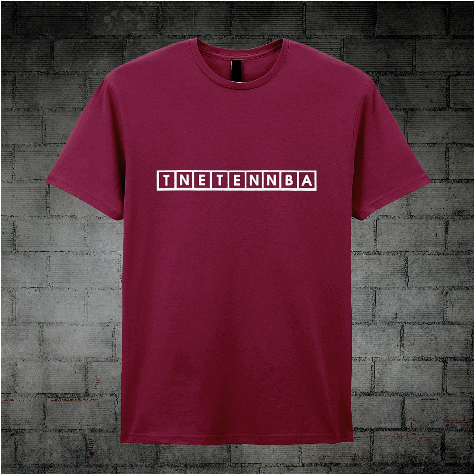 cardinal red unisex T-shirt featuring the text “TNETENNBA” inspired by The IT Crowd, displayed in bold white lettering with a tech-style font.