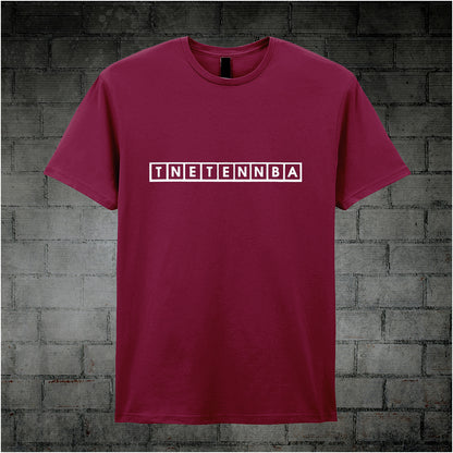 cardinal red unisex T-shirt featuring the text “TNETENNBA” inspired by The IT Crowd, displayed in bold white lettering with a tech-style font.